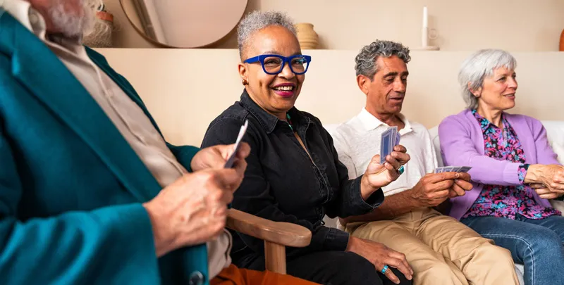 A diverse group of seniors playing cards and having a great time