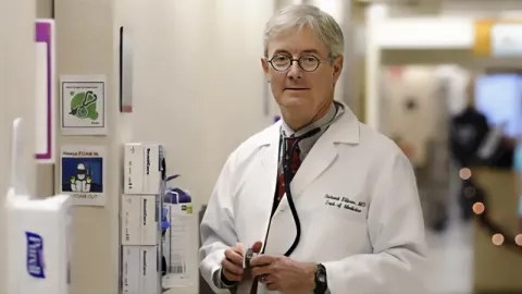 A doctor is shown in the halls of a hosptial.