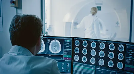 Image of CT scan room with staff